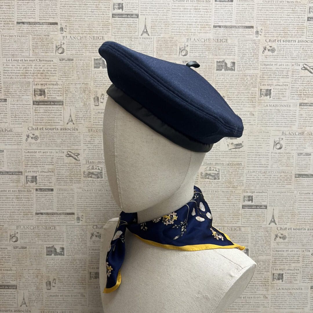 A mannequin wearing a hat and scarf.