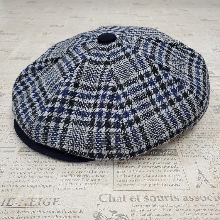 A hat is sitting on the newspaper