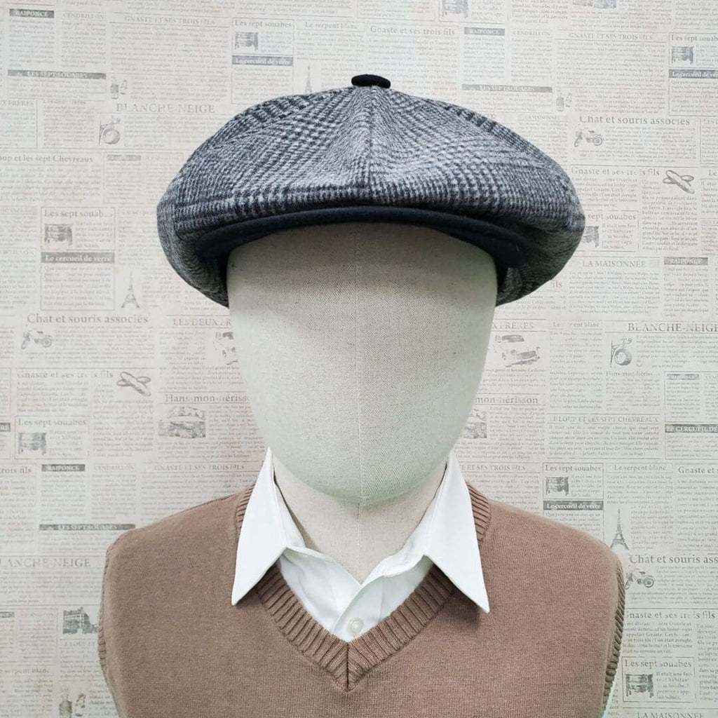 A mannequin wearing a hat and sweater.