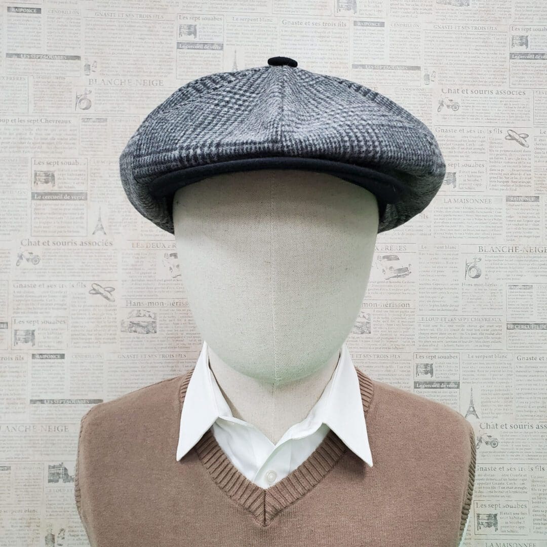 A mannequin wearing a hat and sweater.