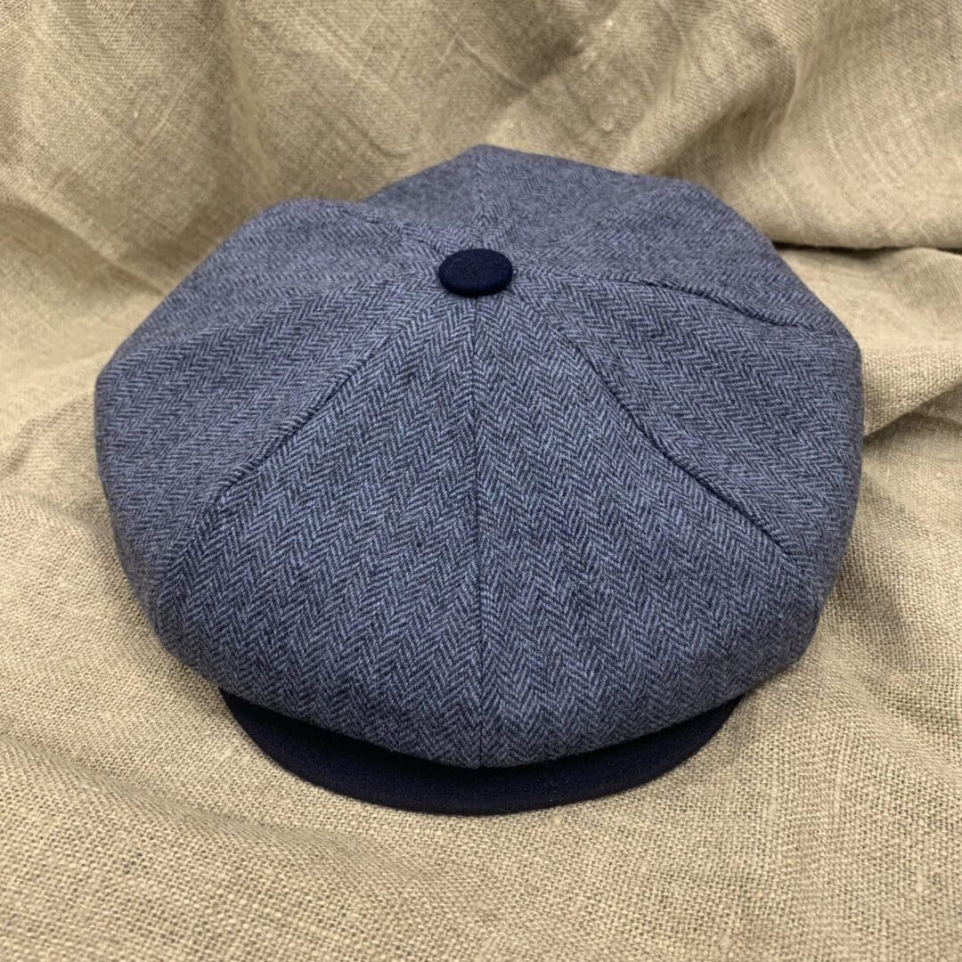 A blue hat is laying on the bed