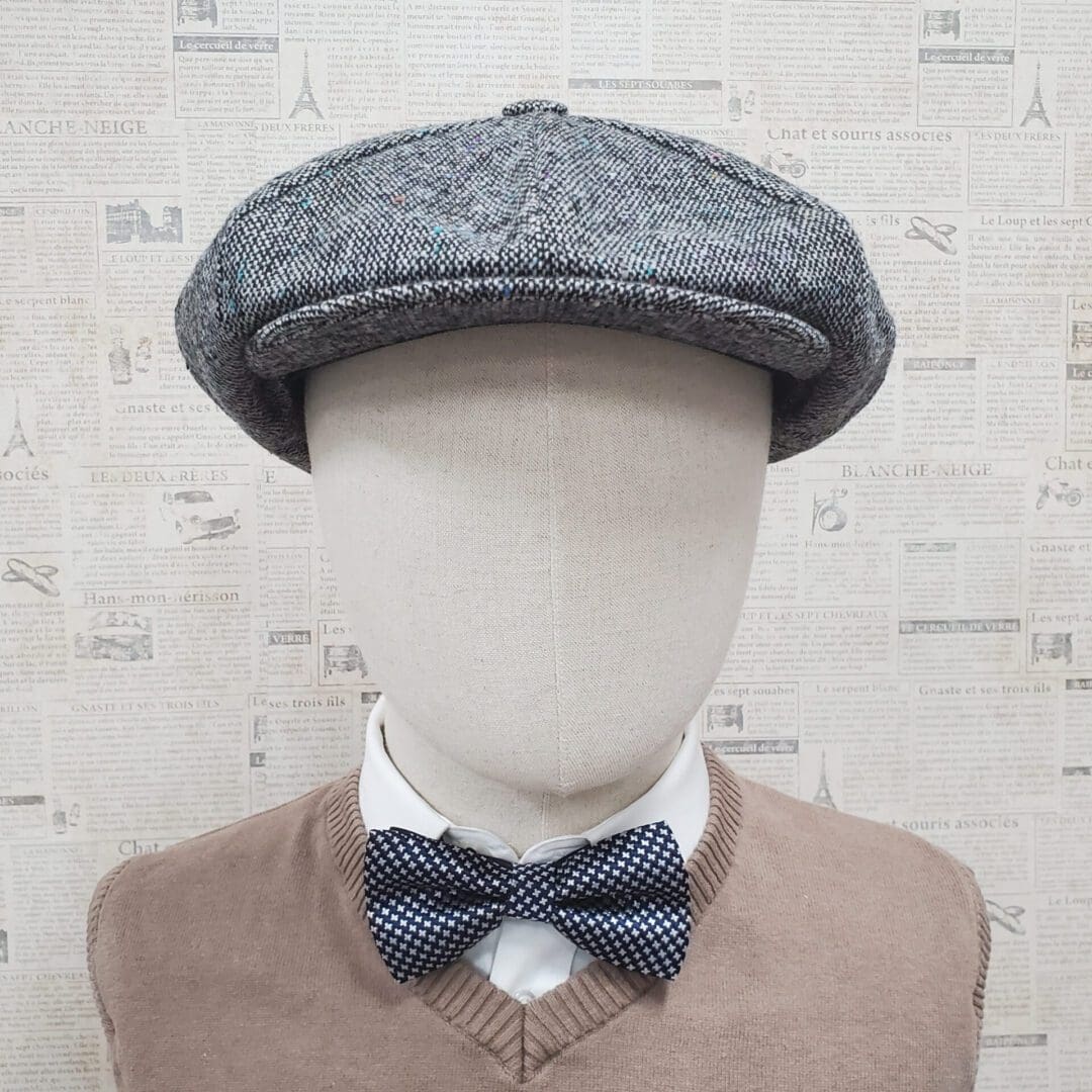 A mannequin wearing a bow tie and a hat.