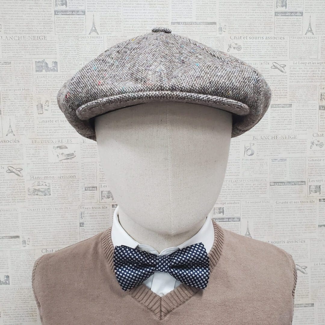 A mannequin wearing a bow tie and hat.