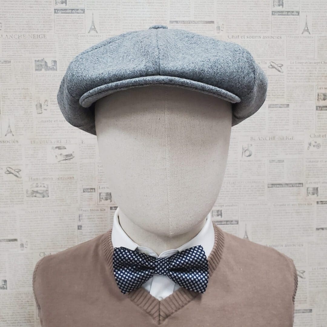 A mannequin wearing a bow tie and hat.