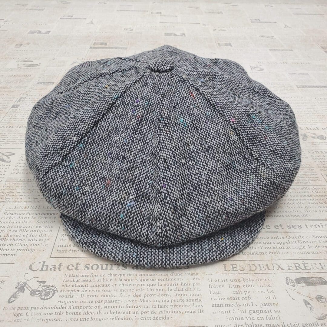 A gray hat is sitting on the floor.