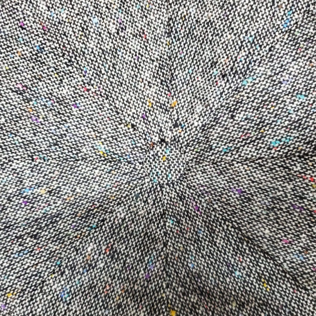 A close up of the center of a gray fabric.