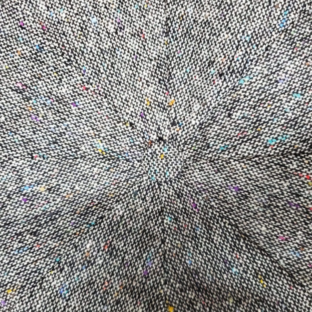 A close up of the center of a gray fabric.