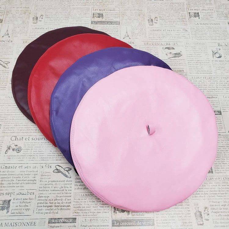 A group of four different colored tires on top of a table.