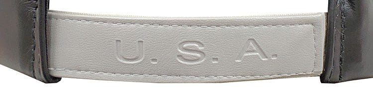 A close up of the u. S. S. Name on a white strap