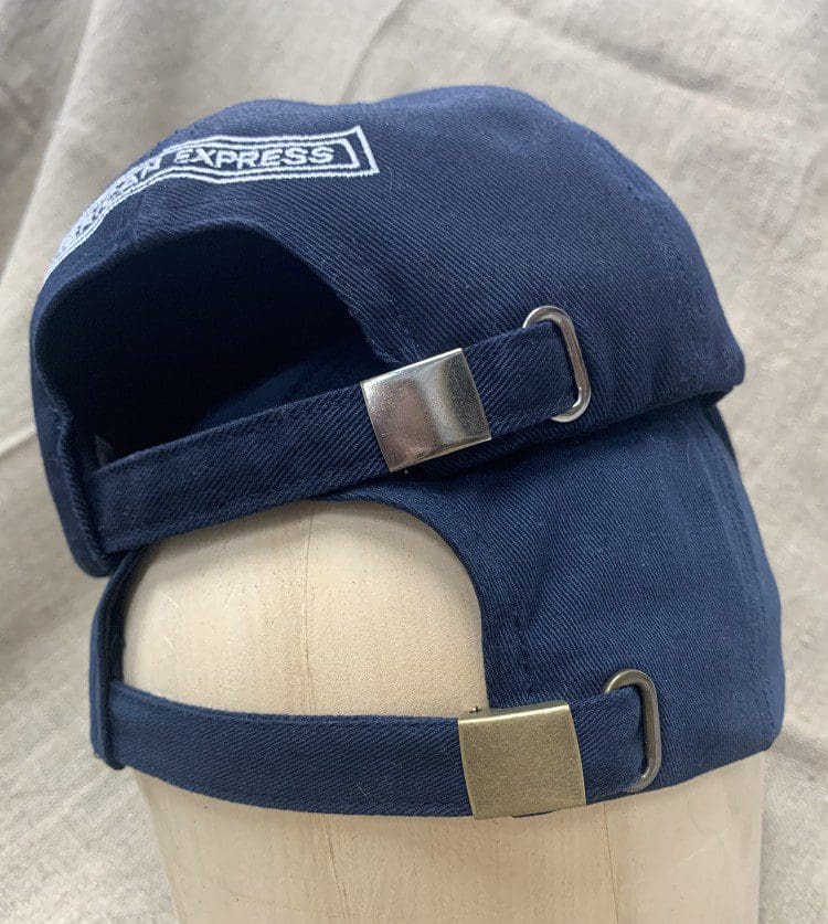 A blue hat with a metal buckle on top of it.