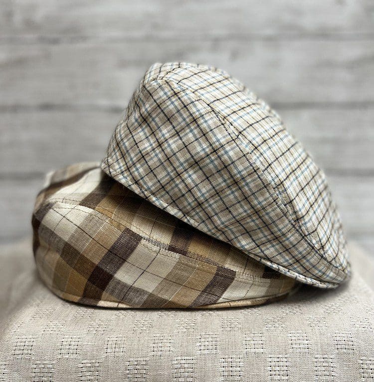 Two hats are sitting on a table.