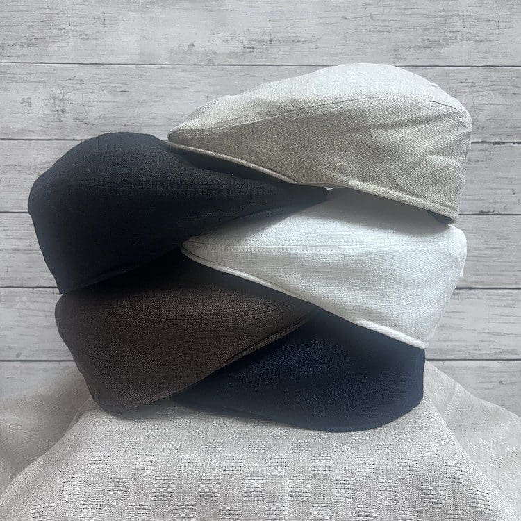 A stack of three different colored hats on top of each other.