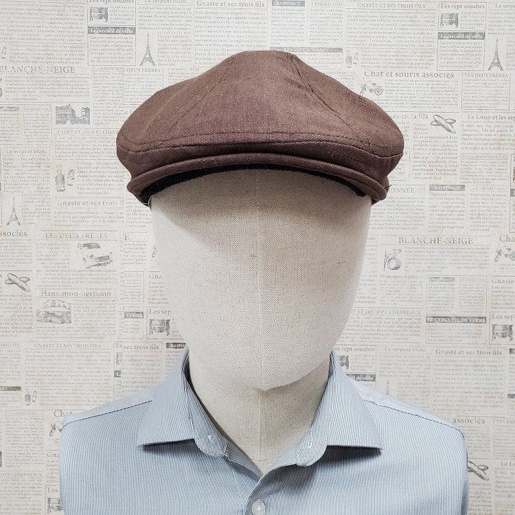 A man wearing a brown hat and blue shirt.