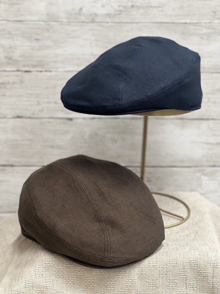 Two hats are sitting on a table.