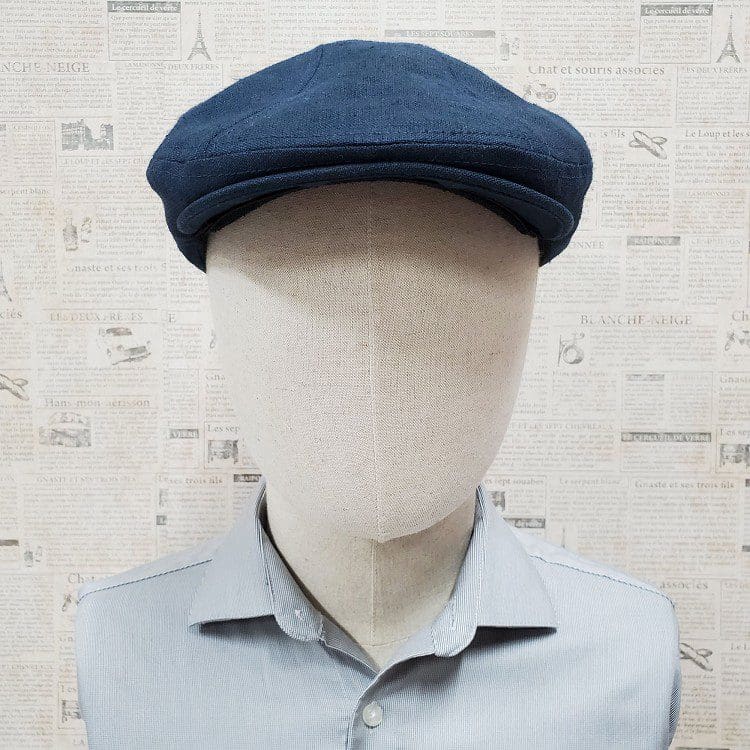 A mannequin wearing a blue hat and shirt.