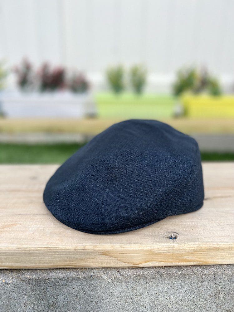 A black hat sitting on top of a wooden table.