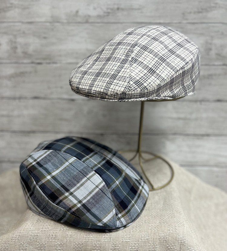 Two hats are sitting on a table.