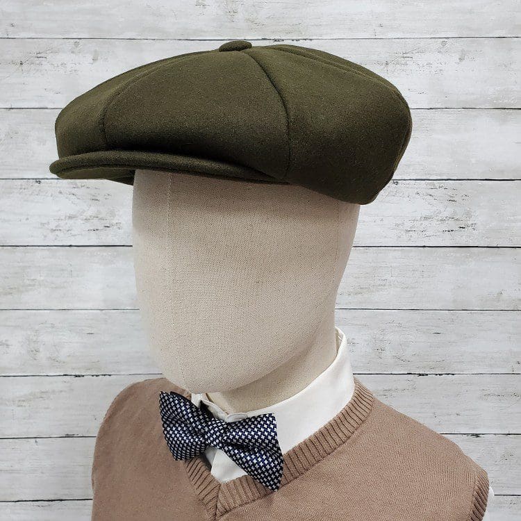 A man wearing a hat and bow tie.