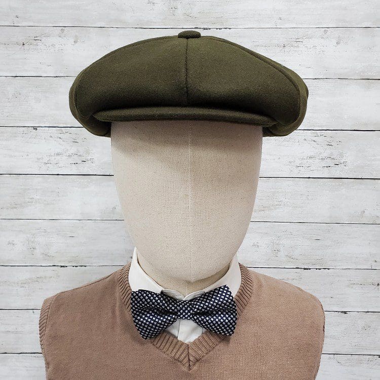A mannequin wearing a bow tie and a hat.