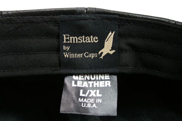 A label on the back of an emstate cap.