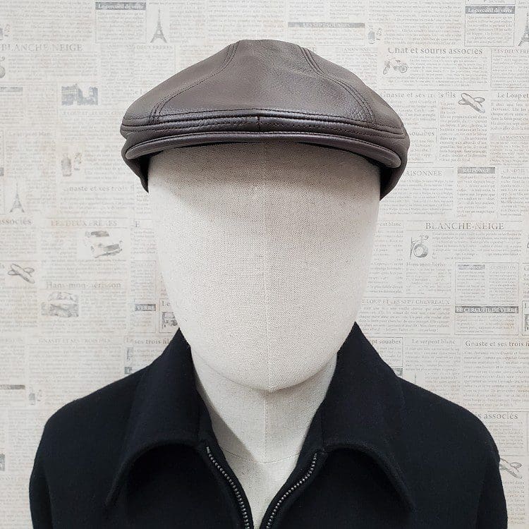 A man wearing a black jacket and hat