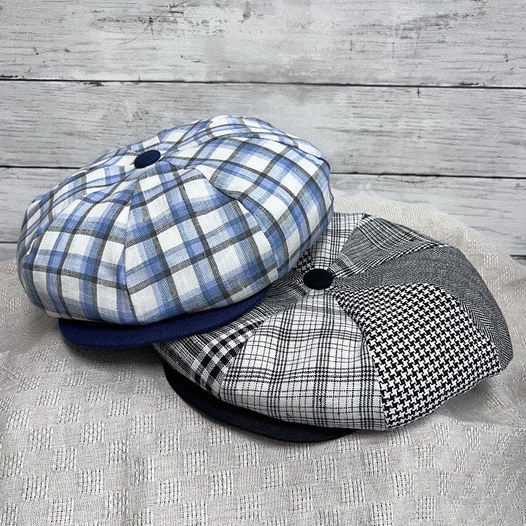 Two hats are sitting on a table.