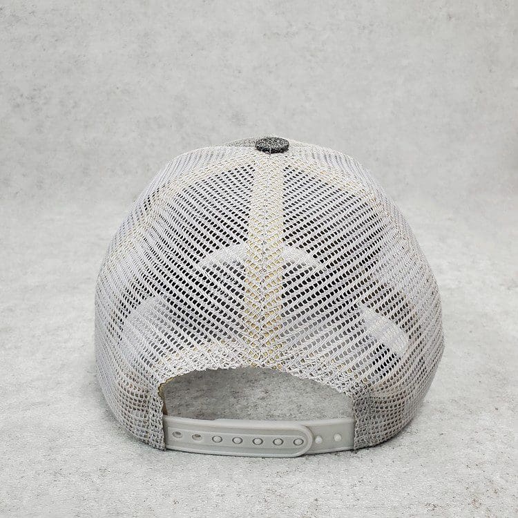 A white hat with a black and silver logo on it.