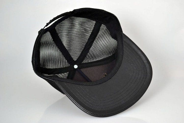 A black hat with a mesh back and a black strap.
